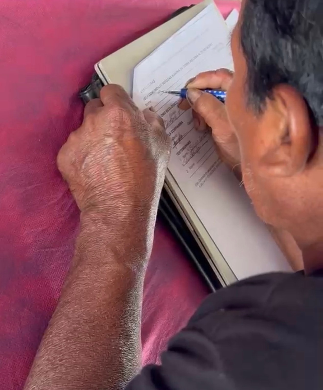Close-up of mandate document being signed — Alto Rio Negro