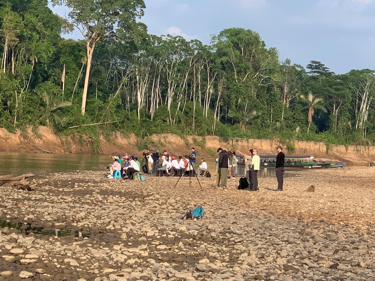 Community gathering on an Amazon riverbank — the people ORO serves